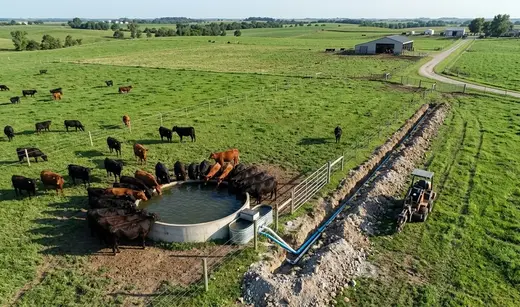 Remote cattle watering system on a North Missouri farm with water tanks, pasture infrastructure, and livestock access improvements