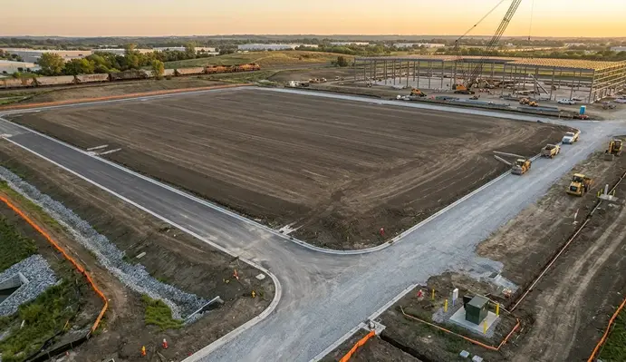 Completed commercial site preparation project with finished grading drainage systems and construction-ready building pads