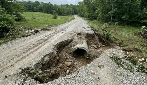 Severe driveway washout and erosion damage caused by poor drainage and stormwater runoff