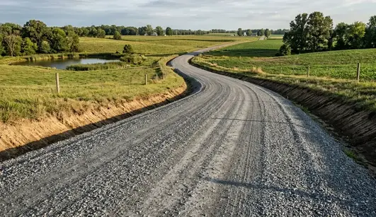 Professionally engineered gravel road in North Missouri with proper crown, drainage ditches, and compacted gravel surface