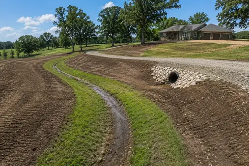 Land grading and drainage correction work shaping soil and controlling water runoff in North Missouri