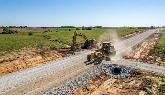 Gravel driveway and rural road construction in North Missouri with heavy equipment grading